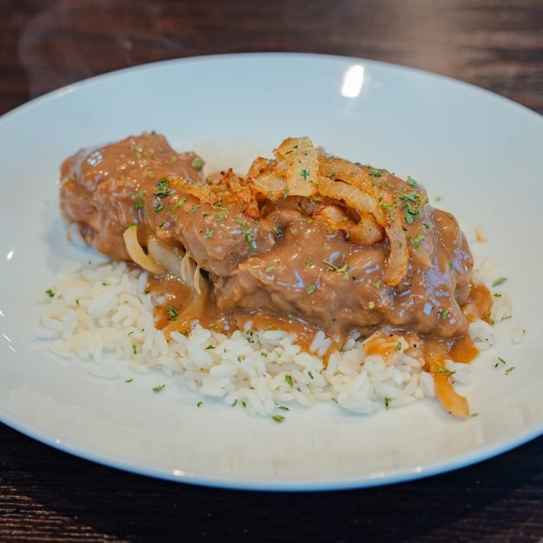 Indulge in Our Smothered Chicken