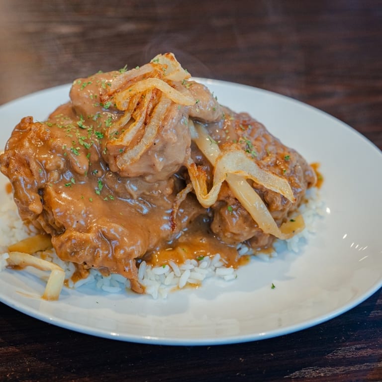 Indulge in Our Smothered Chicken